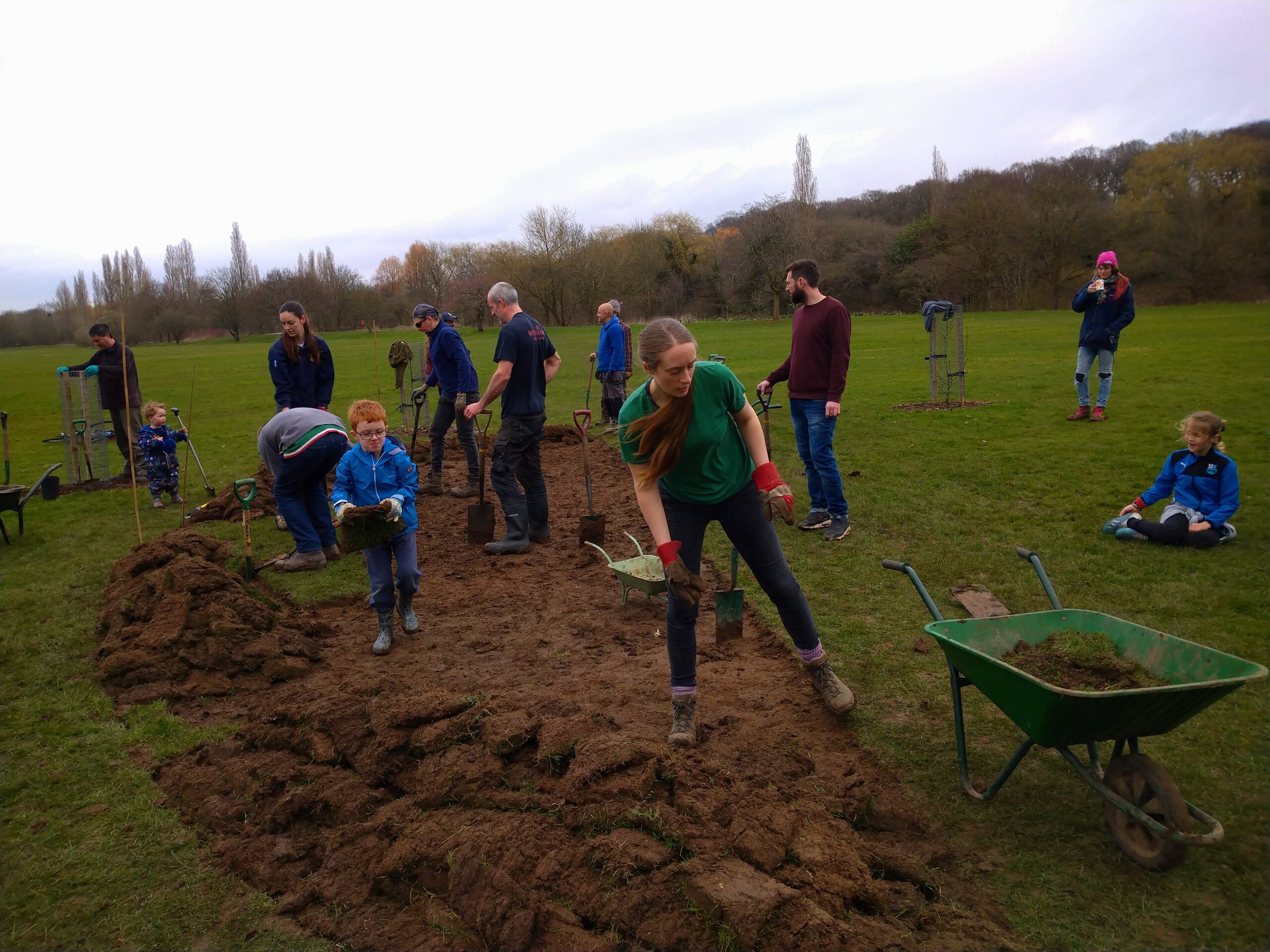 Fruit & Nut Village volunteers of all ages, working outdoors