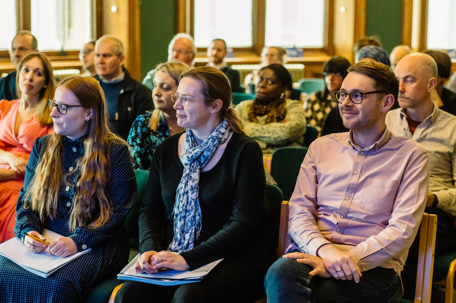 People sitting in rows listening to a talk