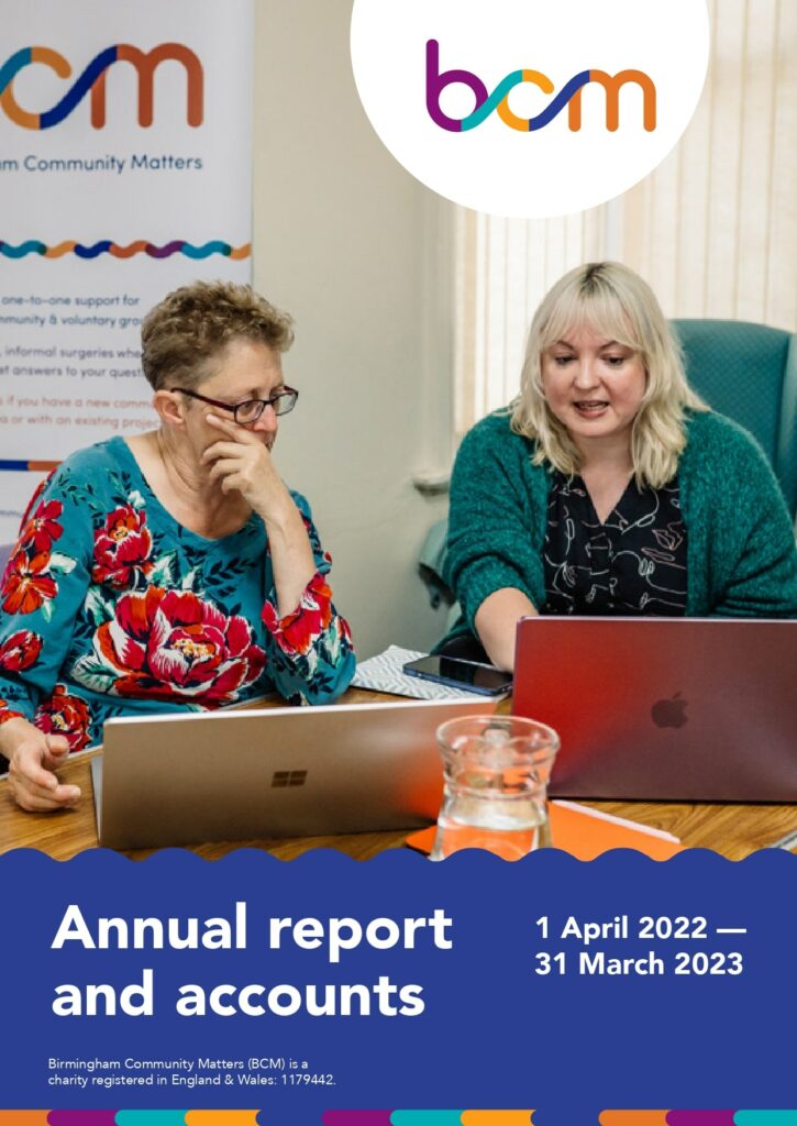 BCM Annual report 2022-2023 cover with Emma Woolf and Kerry Leslie looking at laptops with BCM pull-up banner in the background
